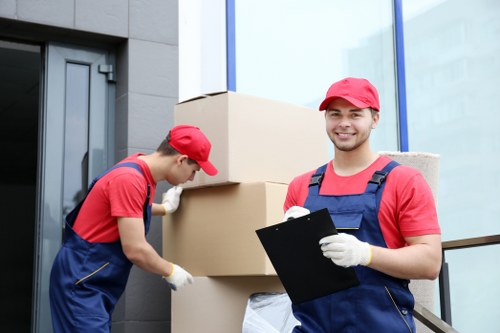 Moving team preparing flat removals in Penge with boxes and furniture