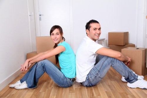 Professional movers handling household furniture in Penge